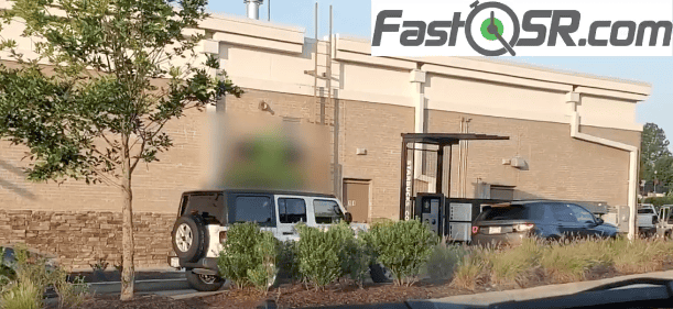 Cars lined up at a drive-thru.